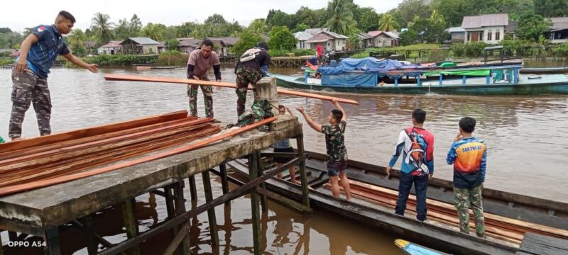 Gunakan Perahu Satgas TMMD Lansir Bahan Bangunan Berupa Kayu.